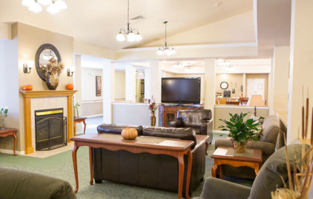 Cozy living room with a fireplace, sofa, and television.