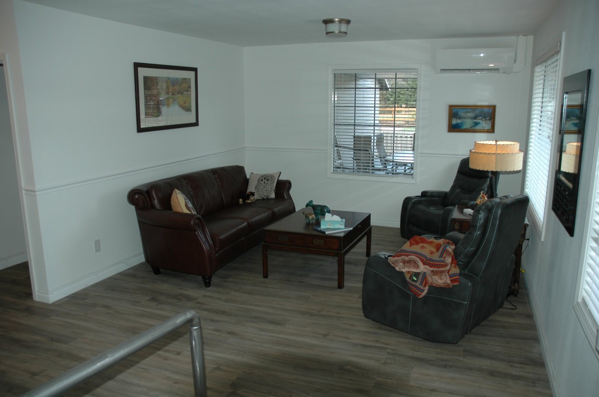 A cozy living room with leather seating and a wooden coffee table.