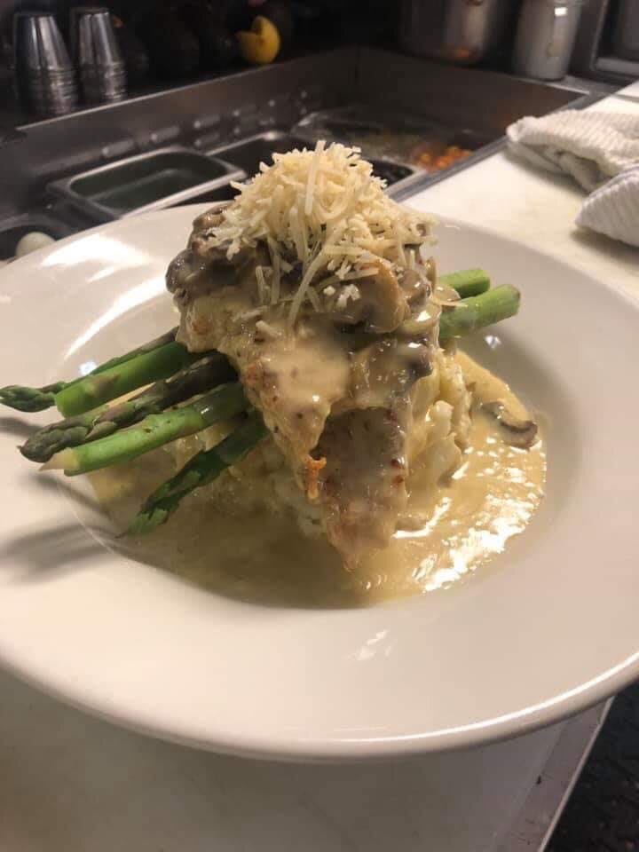 Gourmet dish with meat and asparagus in a creamy sauce.