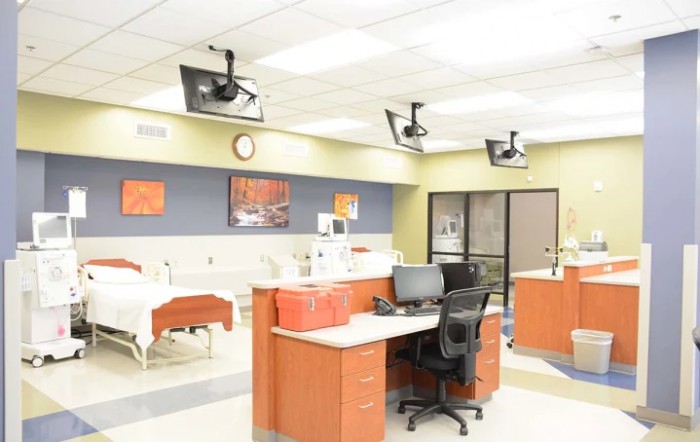 A modern hospital nurses' station with medical equipment and computers.