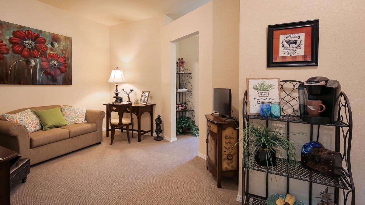 A cozy living room with warm lighting, featuring comfortable furniture and tasteful decor.