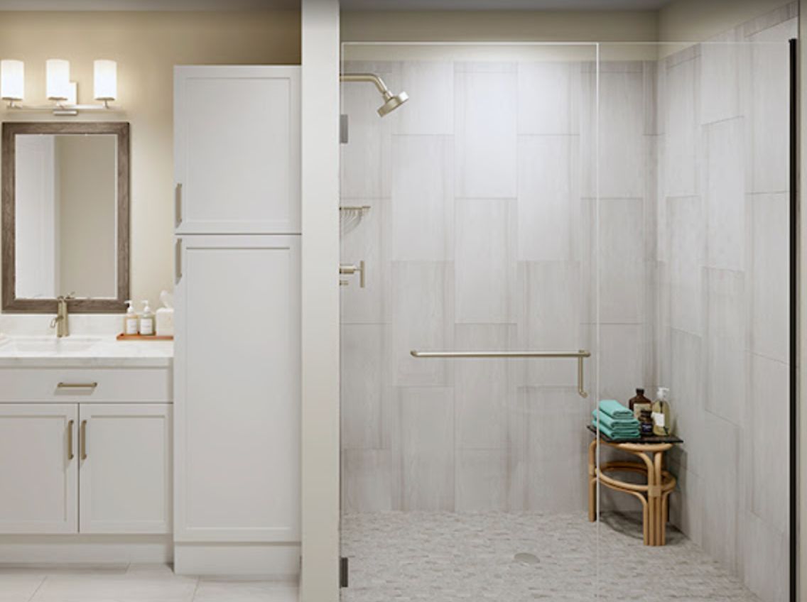 A modern and minimalistic bathroom featuring a walk-in shower with neutral tile flooring and a small set of storage shelves.