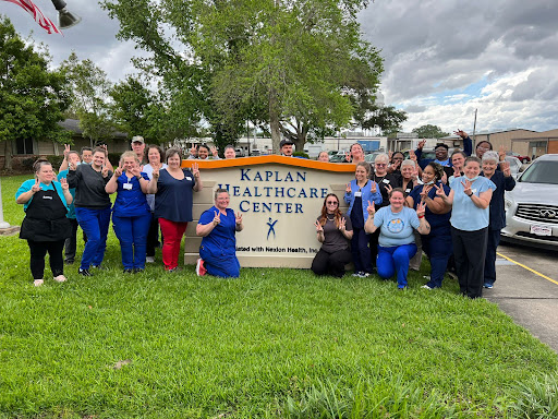 A dedicated team of healthcare workers proudly gathered in front of the Kaplan Healthcare Center.