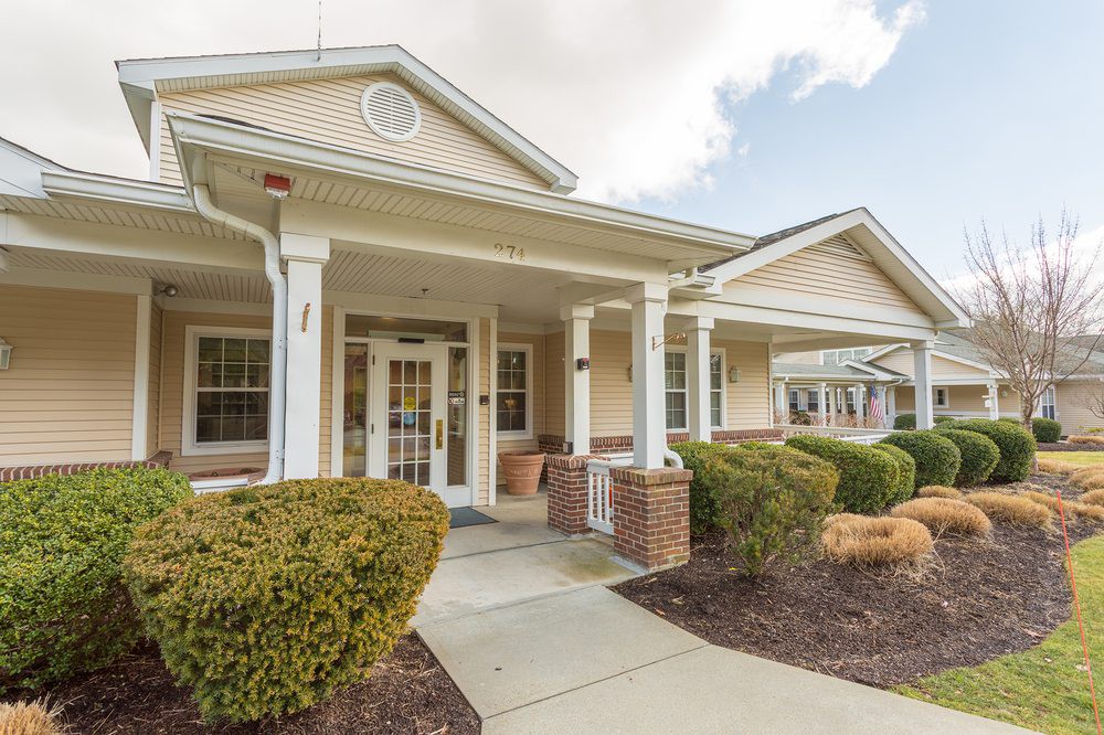 Front view of a building entrance with a porch and columns.