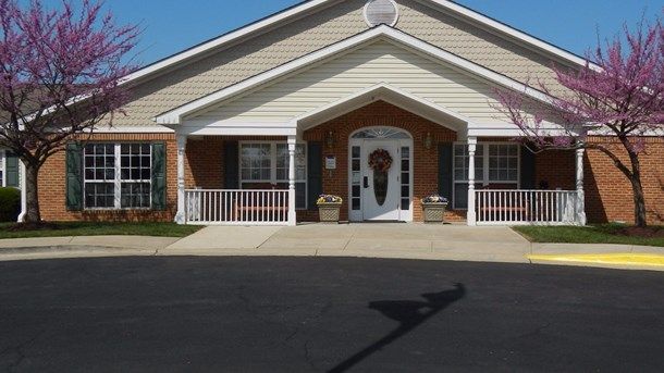 A quaint residential building with a welcoming entrance and a small porch.