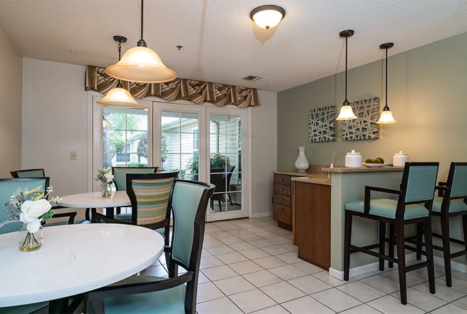 A modern kitchen and dining area with elegant lighting and stylish furniture.