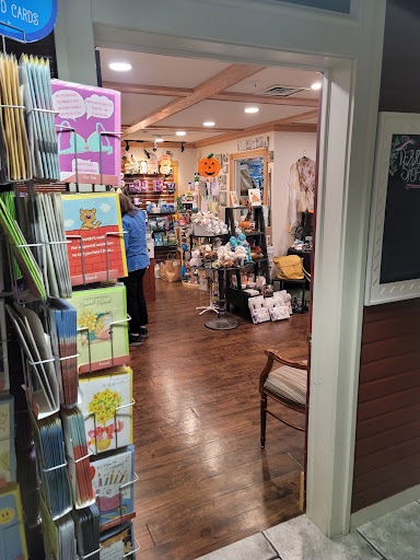 A view inside a cozy gift shop filled with colorful cards and various merchandise.