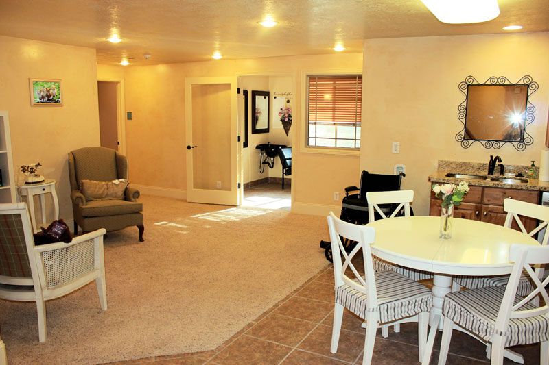 A cozy open living room and dining area with comfortable seating and warm lighting.