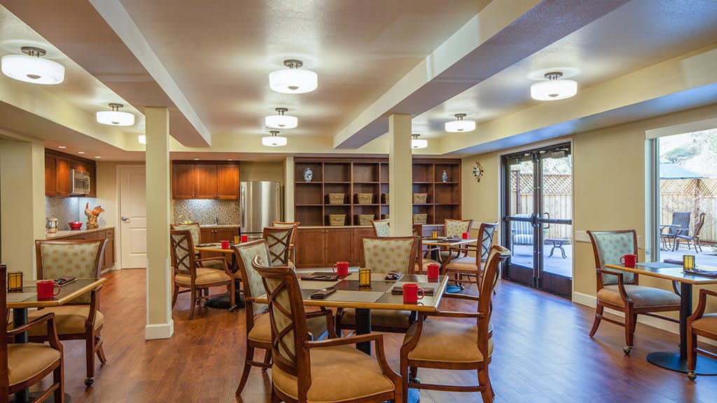 A cozy dining room with wooden furniture and soft lighting.