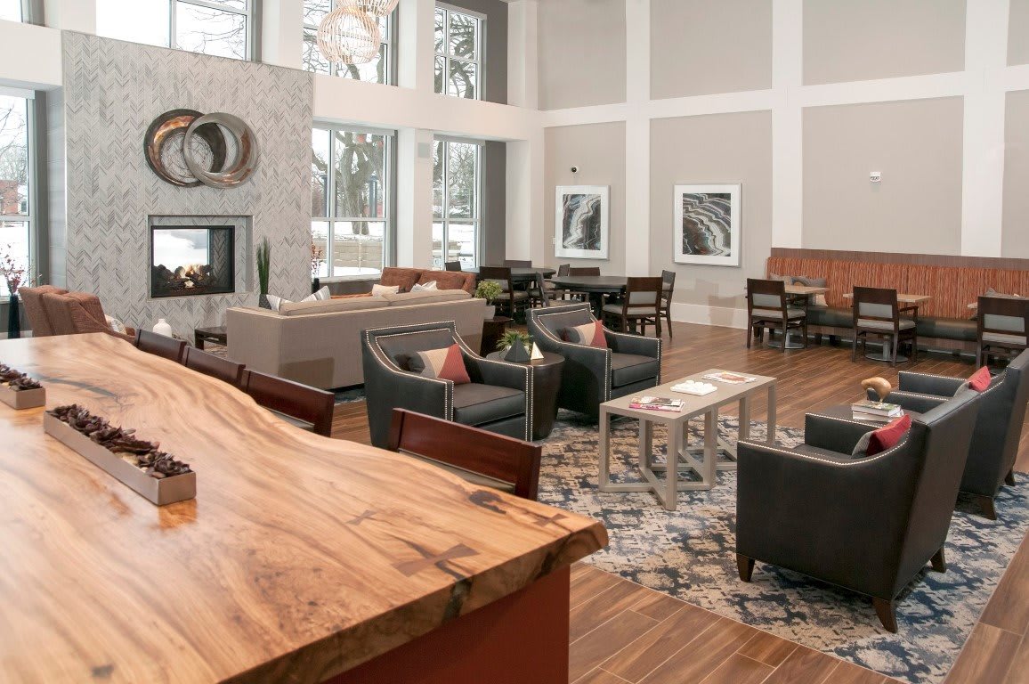 A modern lounge area with stylish furniture and wooden flooring.