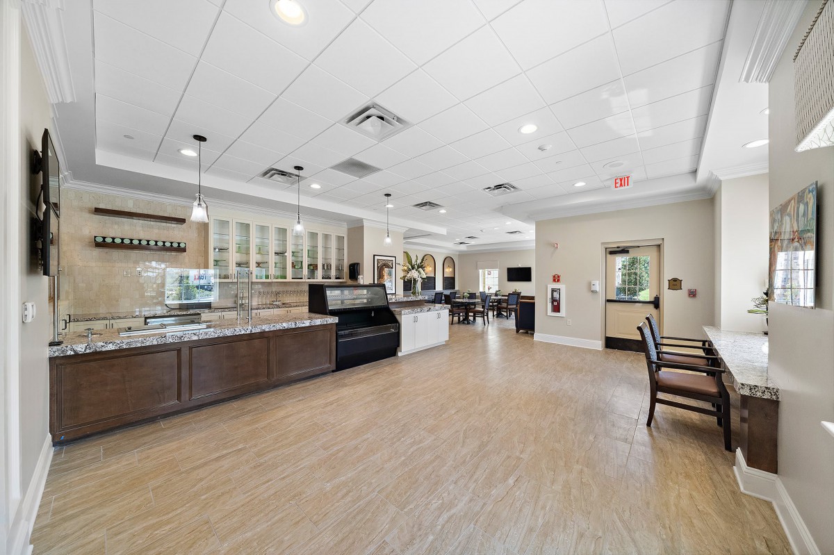Modern cafe interior with seating area and counter.