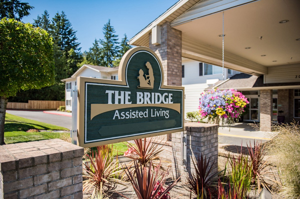 The Bridge Assisted Living entrance with a welcoming sign and landscaped surroundings.