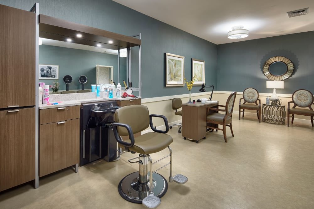 A clean and modern hair salon interior with chairs, mirrors, and beauty products.