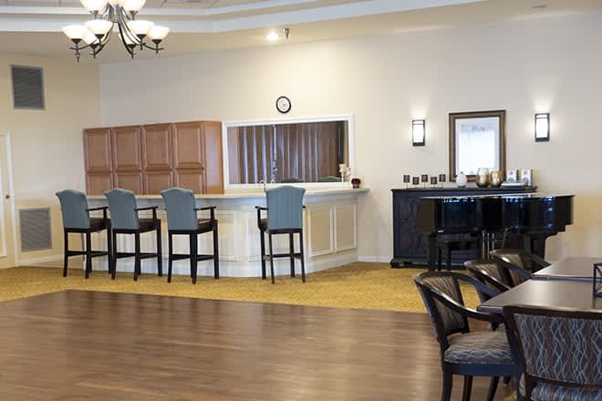 An inviting bar area with high chairs and a stylish counter.