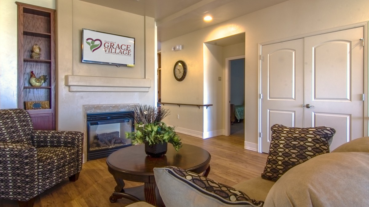 A cozy living room with a fireplace and comfortable seating area.