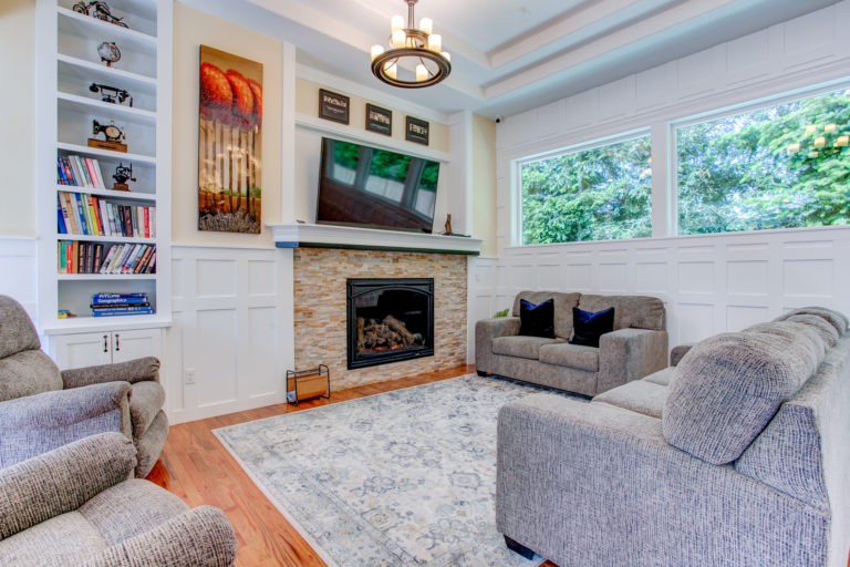 A cozy and stylish living room with a fireplace, television, and comfortable seating.