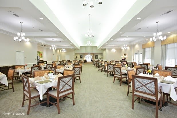 An elegant dining room with neatly arranged tables and chairs ready for guests.