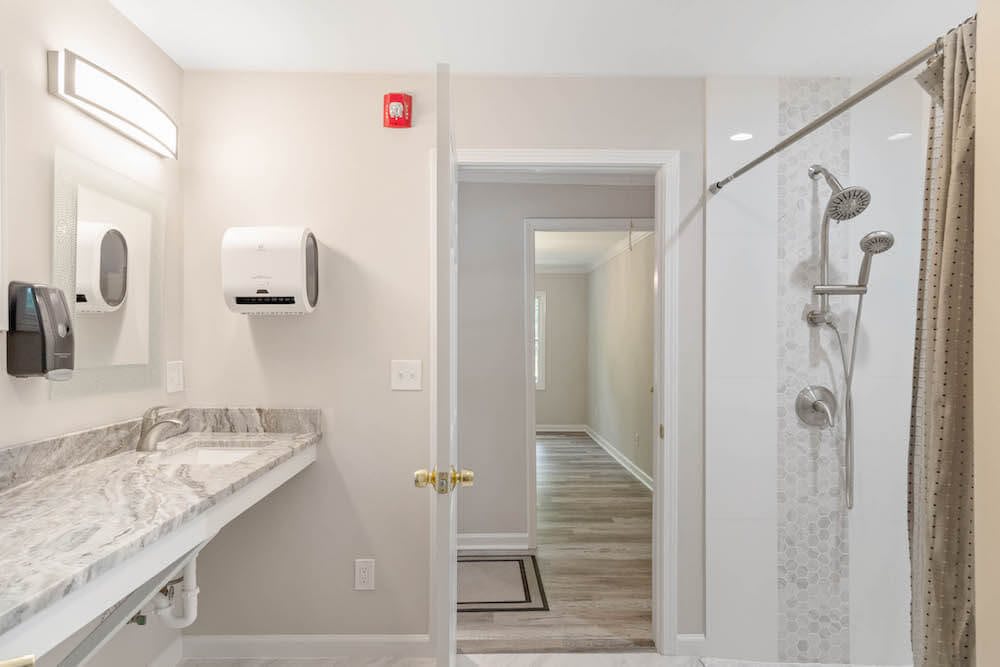 A modern bathroom with a glass shower and a sink.