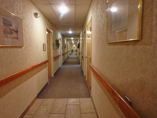 A well-lit hotel hallway showcasing the interior design and architecture.