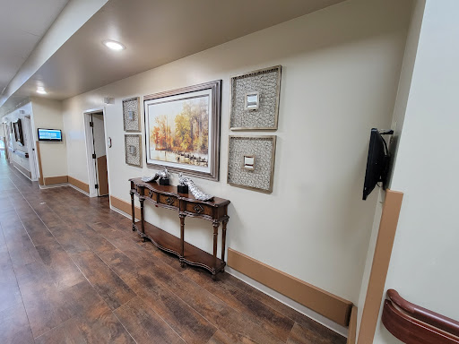 A well-decorated hallway featuring artwork and a wooden table.