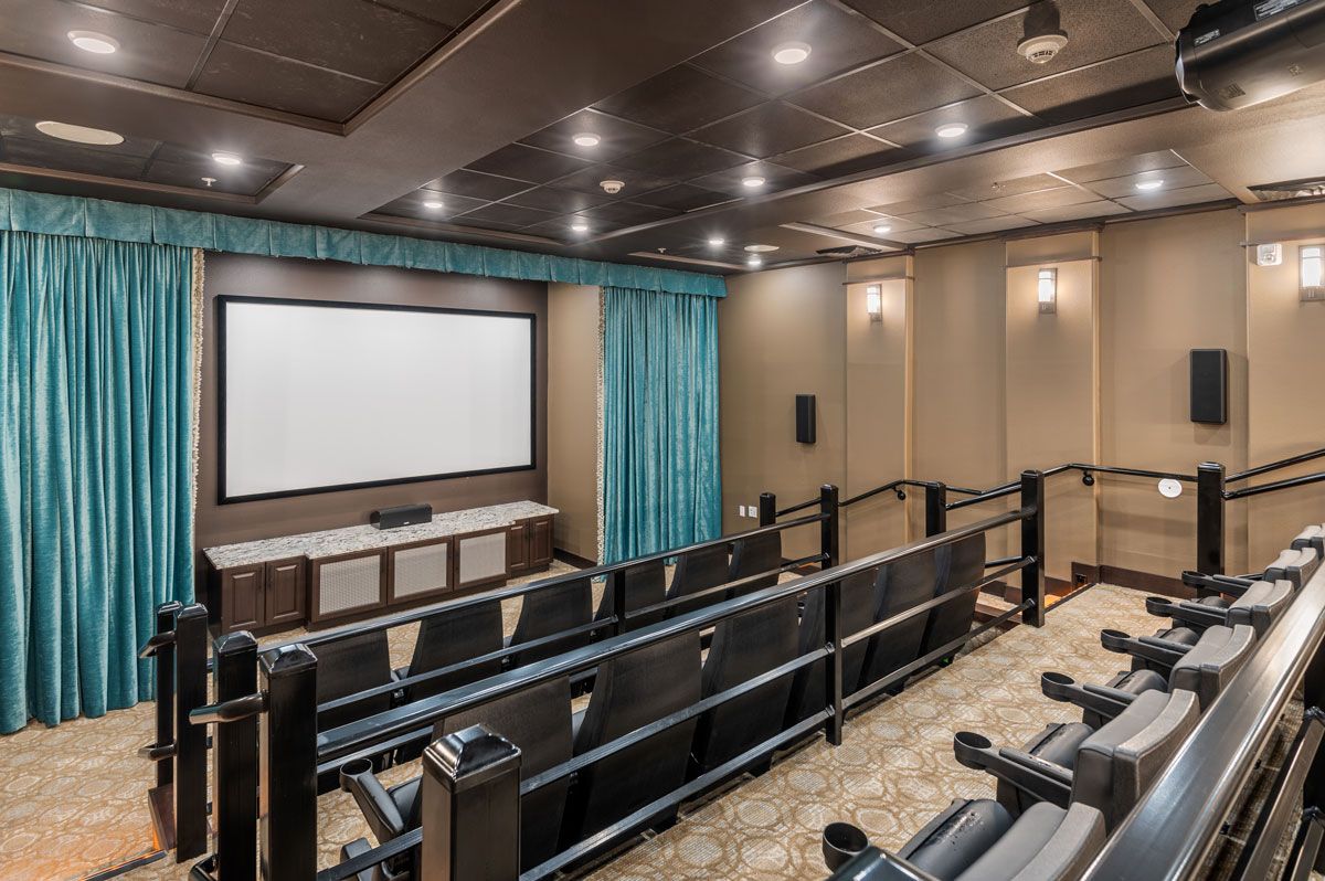 A luxurious home theater setup with tiered seating and a large screen.