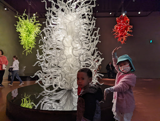 Children exploring a vibrant art installation in a museum.
