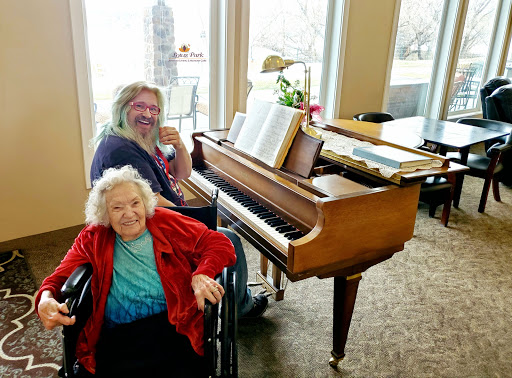 A joyful moment shared between friends at the piano, celebrating music and companionship.