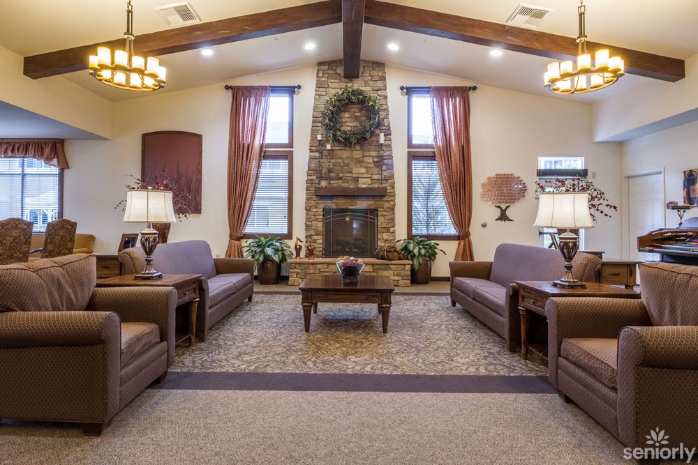 A cozy living room with elegant decor and a central fireplace.