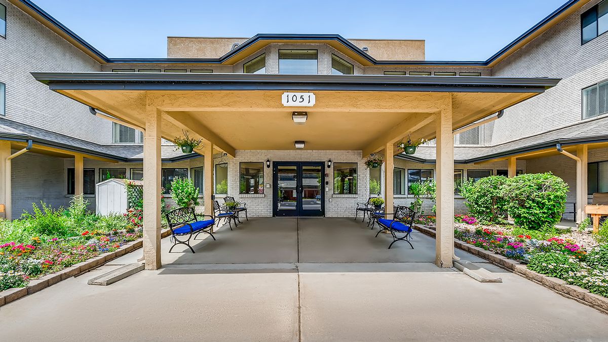 A covered entrance to a building with benches on either side.