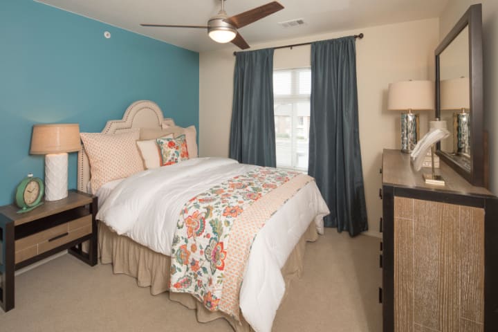 A cozy bedroom with stylish decor and a comfortable bed.