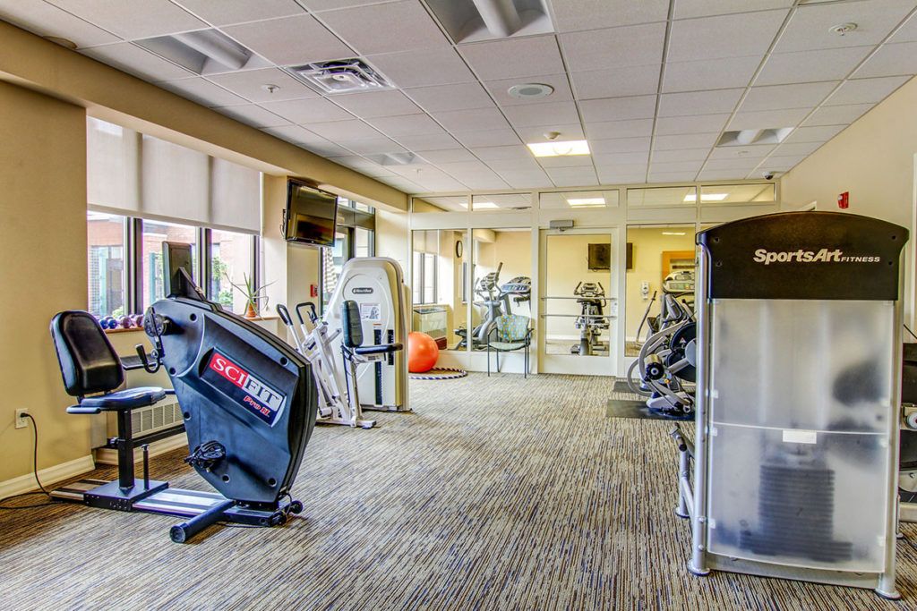 A modern gym featuring various exercise machines, including treadmills and strength-training equipment.