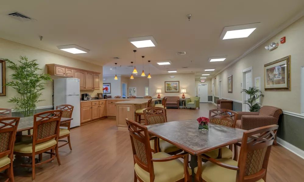 A spacious kitchen and dining area featuring modern lighting and wood flooring.