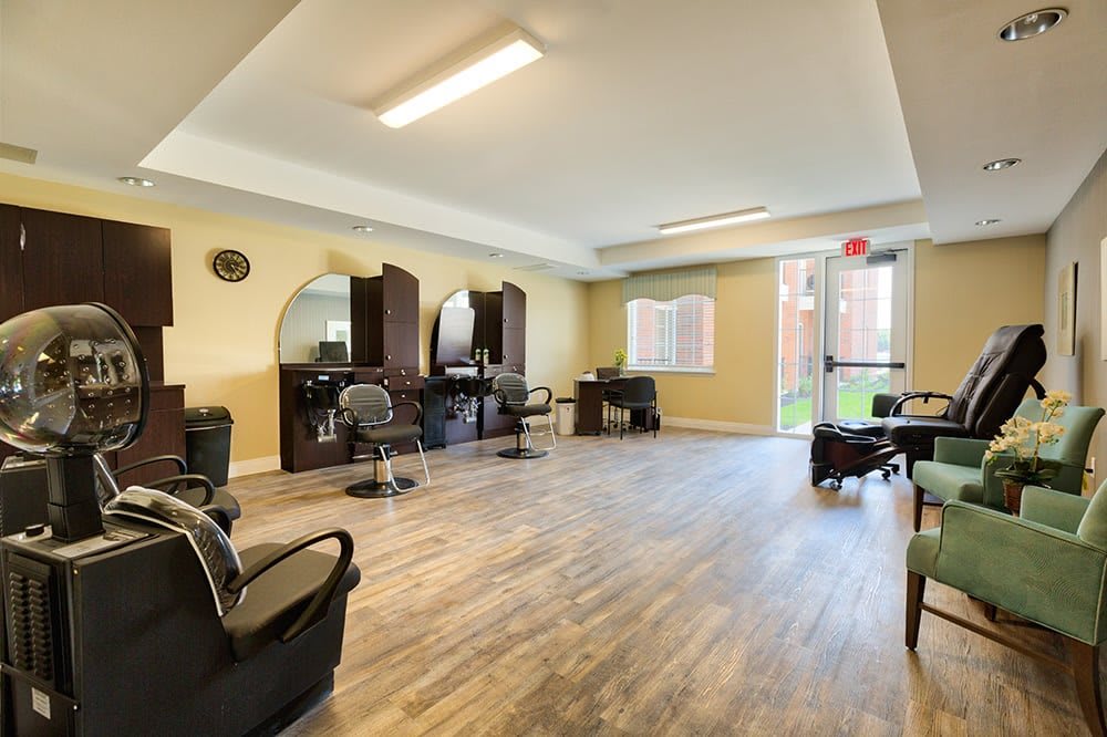 A bright and spacious salon interior with chairs, mirrors, and modern furniture.