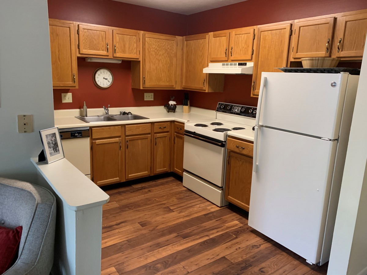 A cozy kitchen with wooden cabinets and modern appliances.