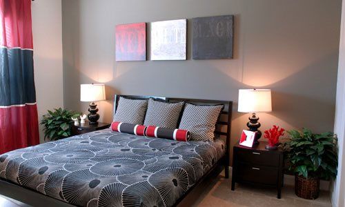 A modern bedroom with stylish bedding and contemporary decor.