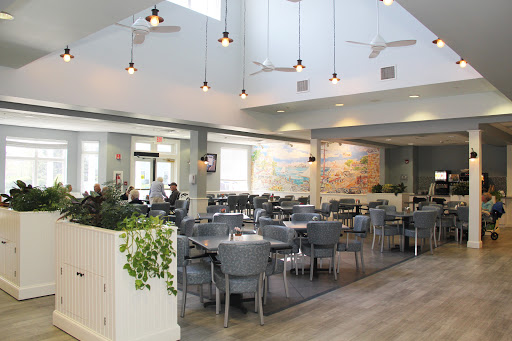 A spacious and modern restaurant interior featuring stylish furnishings and ambient lighting.