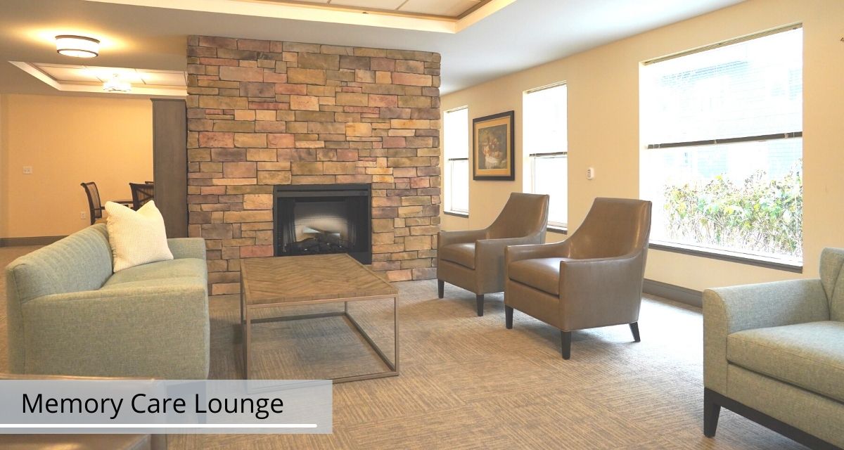 A cozy lounge area featuring a brick fireplace, two chairs, and a glass coffee table.