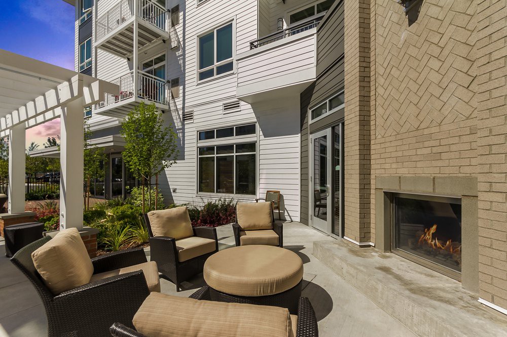 A modern outdoor patio with comfortable seating in a residential building.