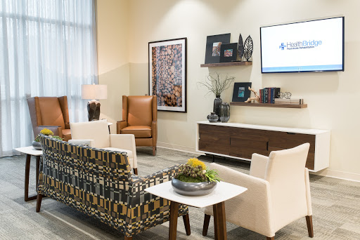 A modern waiting area featuring stylish furniture and decorative elements.
