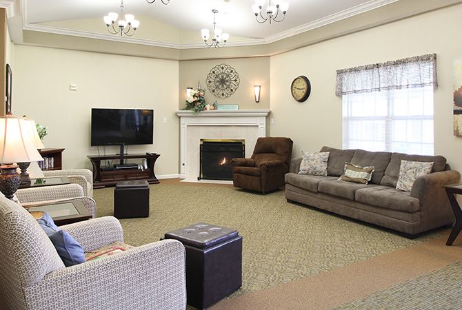A cozy living room with comfortable seating and a fireplace.