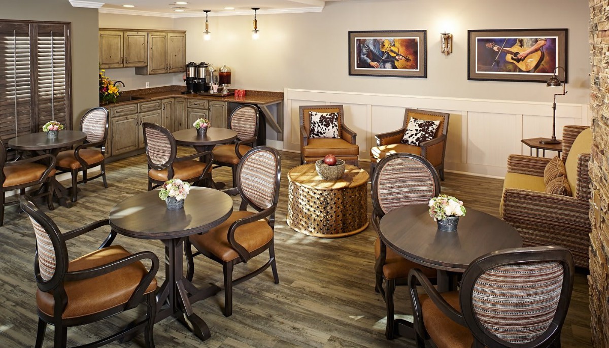A cozy seating area with round tables, cushioned chairs, and elegant decor.