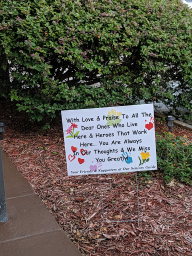 A heartfelt sign honoring loved ones and heroes, expressing ongoing thoughts and memories.