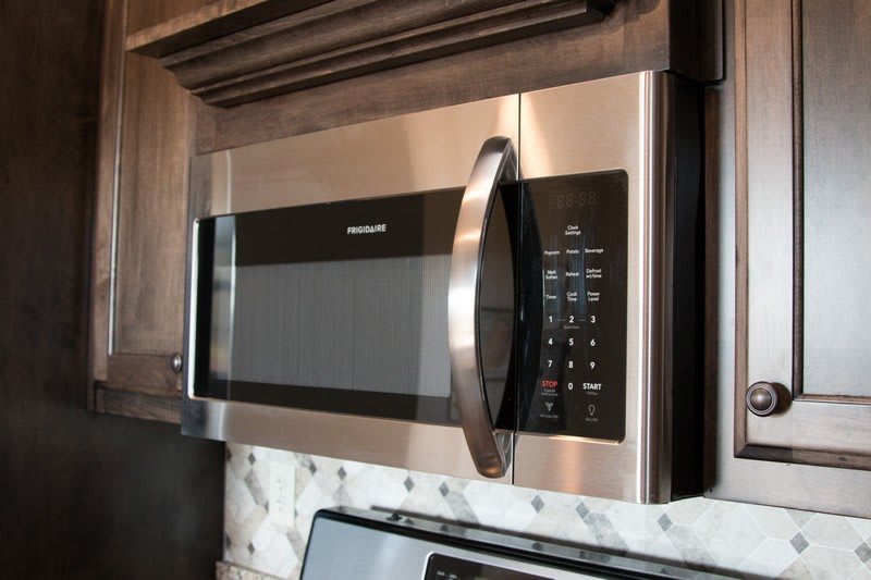 A stainless steel over-the-range microwave in a kitchen setting.