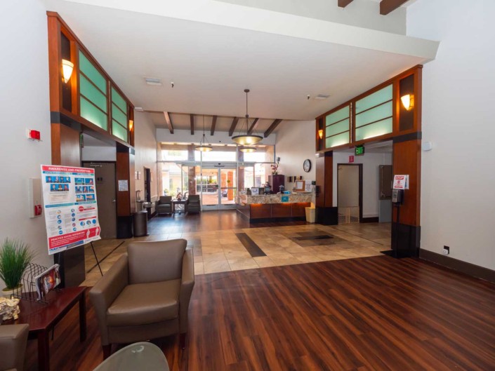 A spacious and modern lobby with a reception desk and seating area.