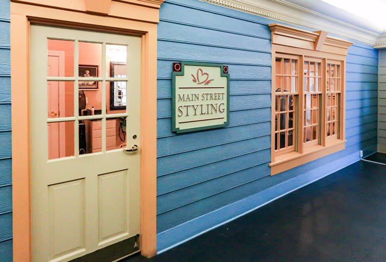 The entrance of a shop named 'Main Street Styling' with a blue exterior and beige accents.