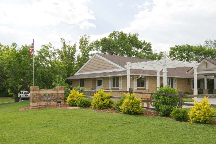 A charming house with a well-maintained lawn and lush garden.