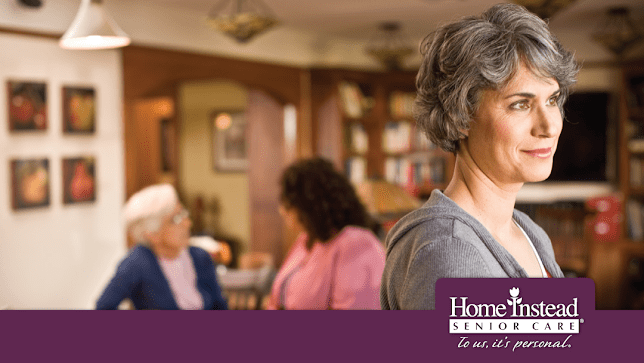 Elderly people socializing in a cozy nursing home environment.