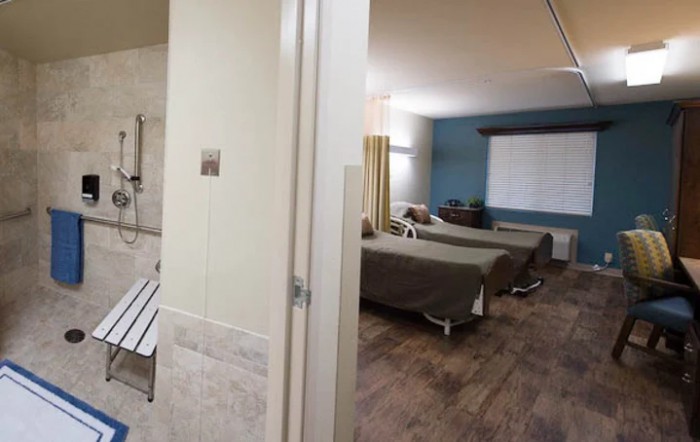 A clean and modern healthcare room with multiple beds.