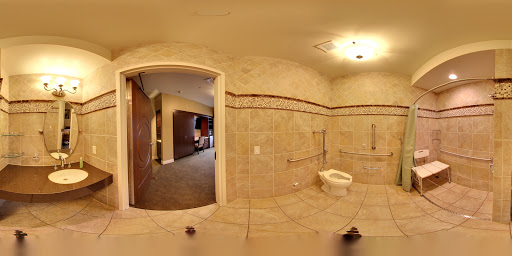 A spacious and modern bathroom featuring tiled walls and floor.
