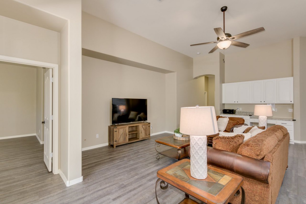 A modern living room with a cozy sofa, large TV, and stylish decor.